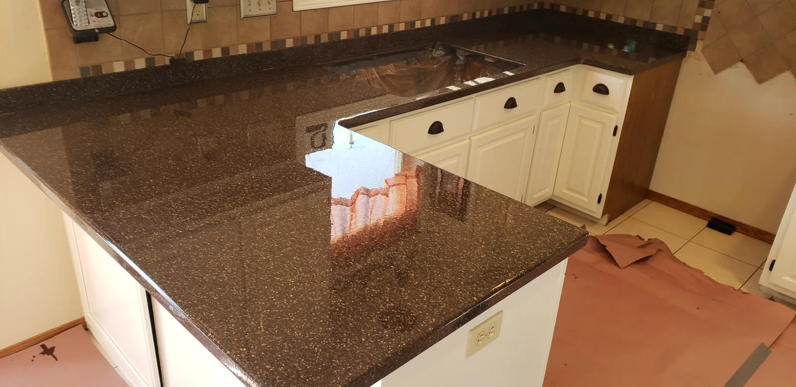 Epoxy restored kitchen countertop in a brown granite look by DC Coatings, Green Bay, WI
