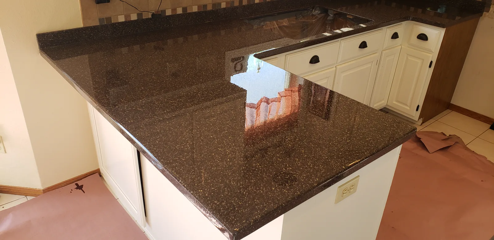 Epoxy restored kitchen peninsula countertop in a brown granite look by DC Coatings, Green Bay, WI