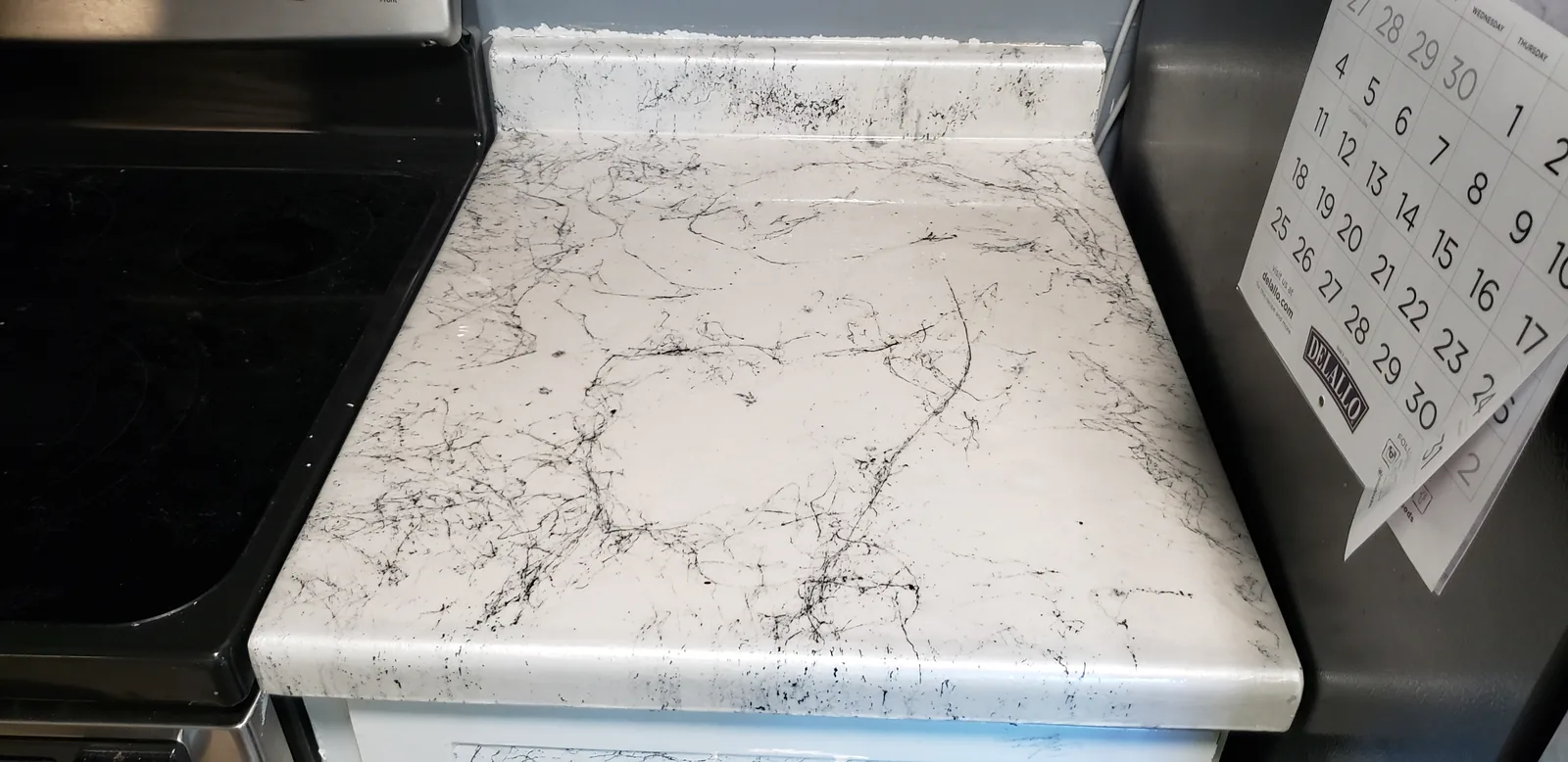 Epoxy restored kitchen countertop in a white marble look by DC Coatings, Green Bay, WI