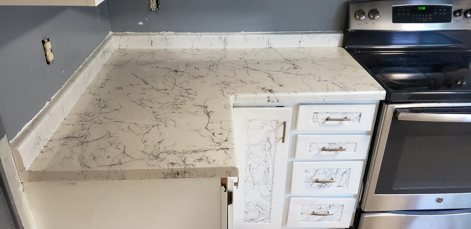 Epoxy restored kitchen countertop in a white marble look by DC Coatings, Green Bay, WI